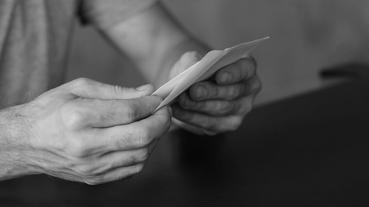 man opening legal letter