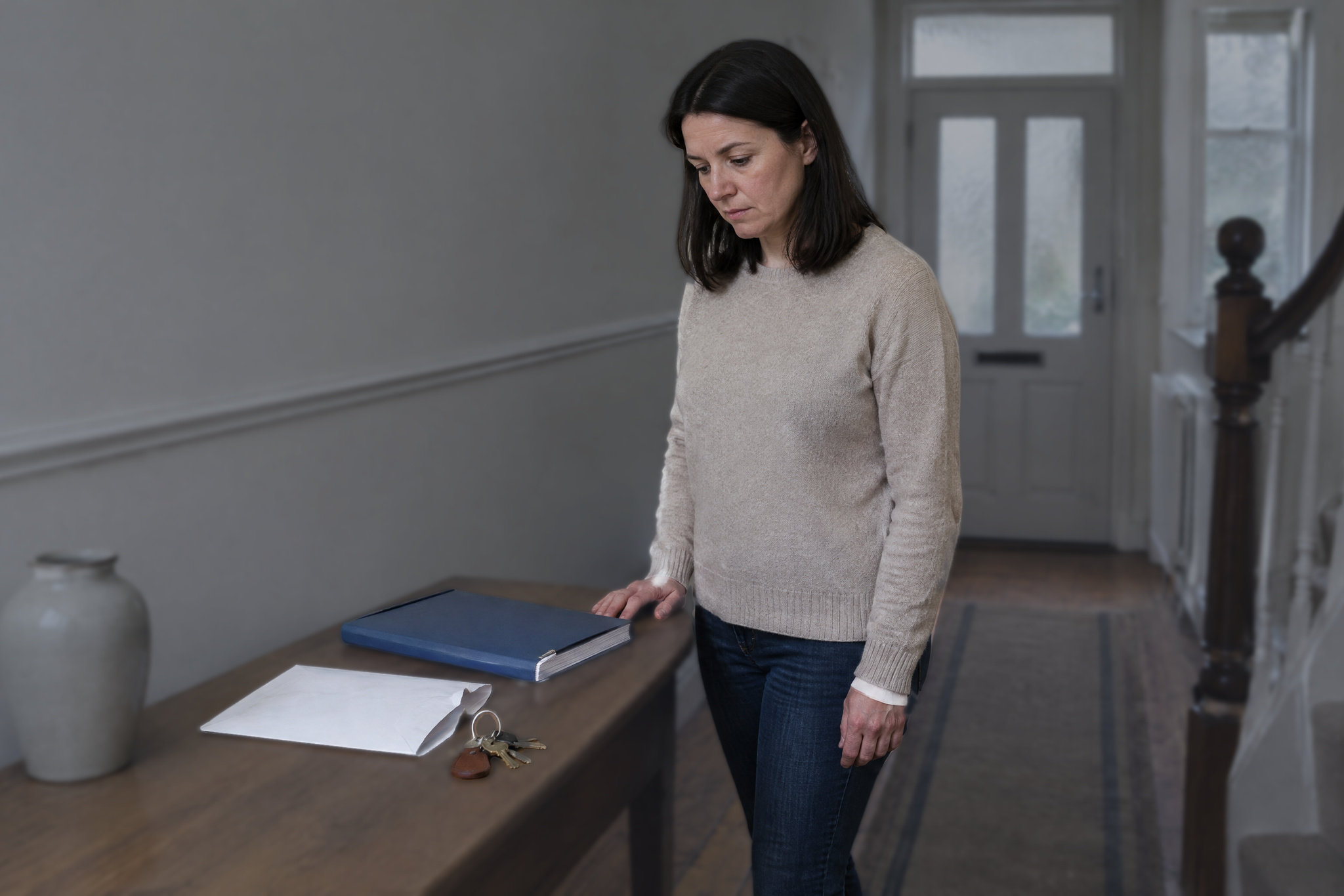 Woman looking at documents after receiving an Unexplained wealth order