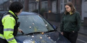 Police officer and woman inspecting an egged car on Halloween offences