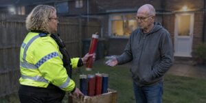 Police officer questioning a man about fireworks on Bonfire Night