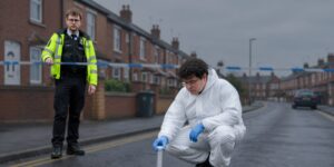 Forensic officer recovering a knife at scene during an attempted murder investigation
