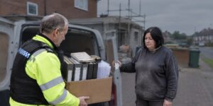 Officer seizing builder's job files during a false representation investigation