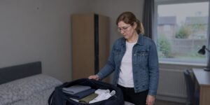 Worried mother packing a bag at home, wondering can a child under 18 go to prison